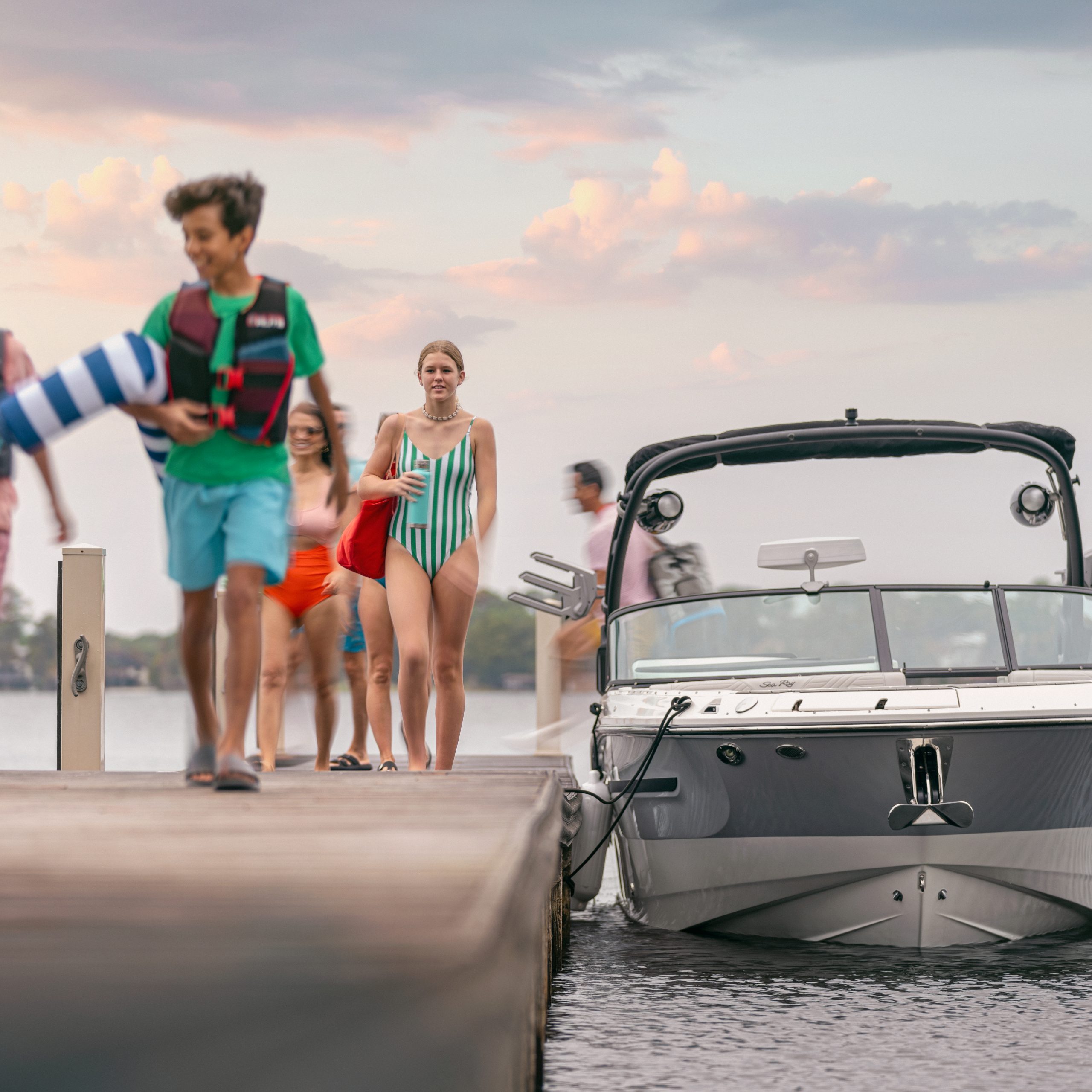 People walking on a dock next to an SDX 270 Surf