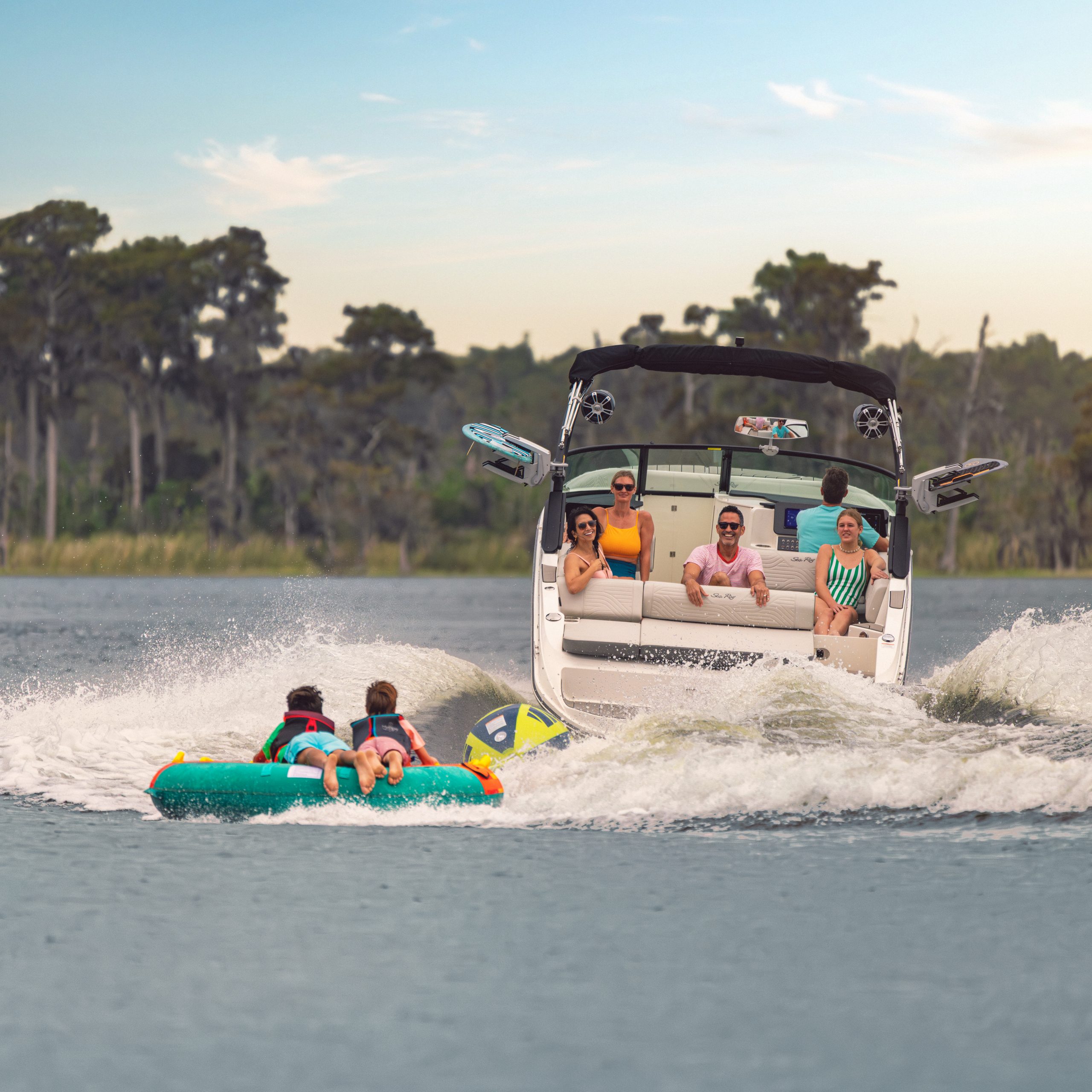 Friends tubing behind an SDX 270 Surf